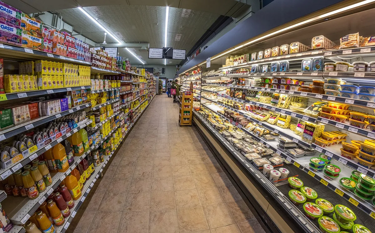 A supermarket aisle with refrigerated display cabinets